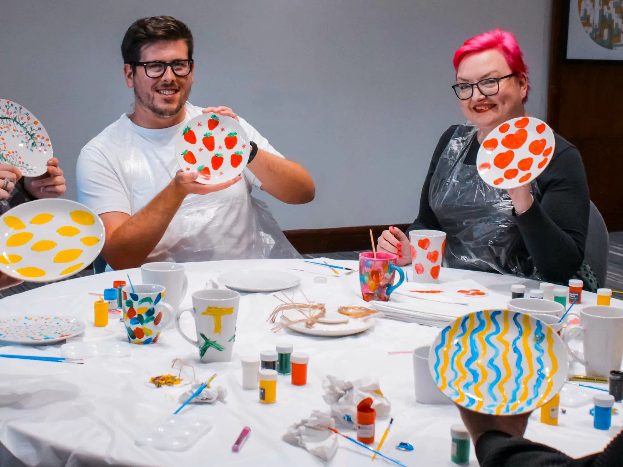 Team decorating ceramics at a creative painting workshop in Manchester